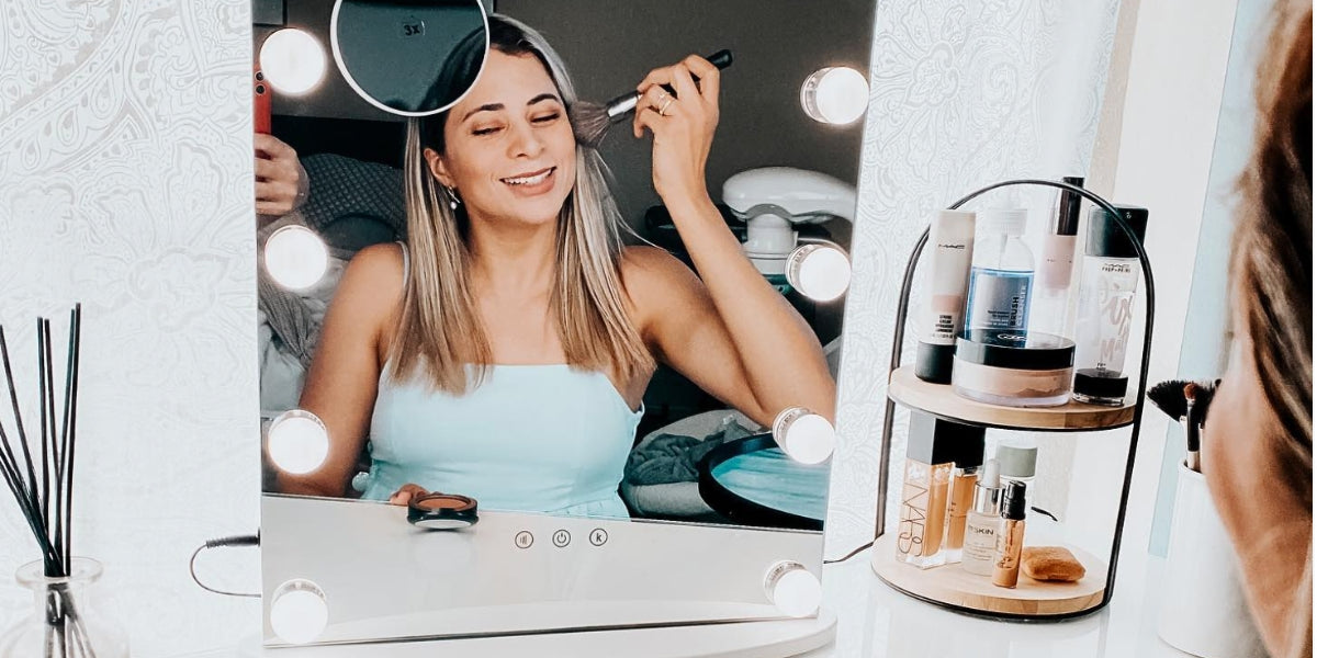 A woman putting her blush on in front of LUXFURNI Makeup Mirror