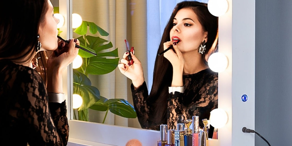 A woman putting her makeup in front of LUXFURNI Makeup Mirror
