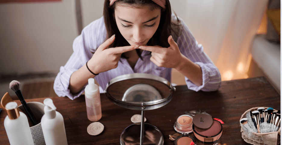 Woman doing her daily morning makeup routine